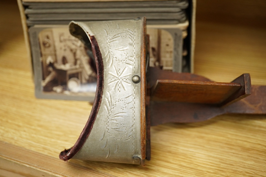 A stereoscope viewer with a collection of comical viewing cards. Condition - cards - fair/good, viewer - poor